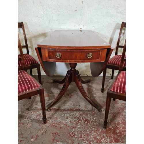 116 - A Regency style mahogany drop leaf pedestal dining table with two drawers, brass lion paw supports a... 