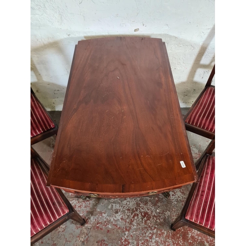 116 - A Regency style mahogany drop leaf pedestal dining table with two drawers, brass lion paw supports a... 