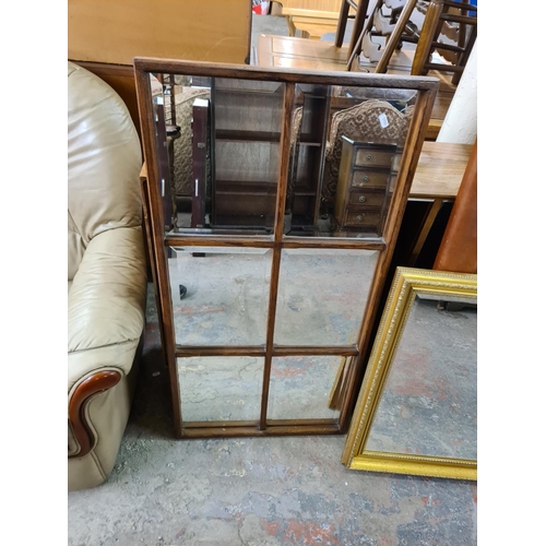 133 - Three modern wall mirrors, one brown leatherette framed, one gilt framed and one oak framed