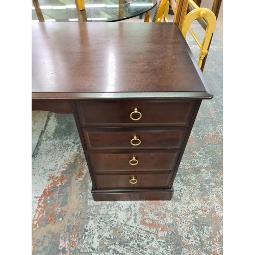 143 - A Stag Minstrel mahogany pedestal desk with eight drawers - approx. 76cm high x 148cm wide x 64cm de... 