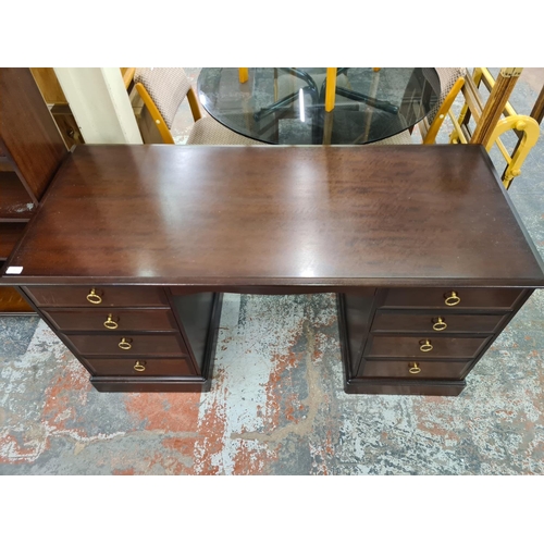 143 - A Stag Minstrel mahogany pedestal desk with eight drawers - approx. 76cm high x 148cm wide x 64cm de... 