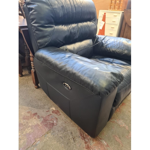 64 - A modern black leather electric reclining armchair