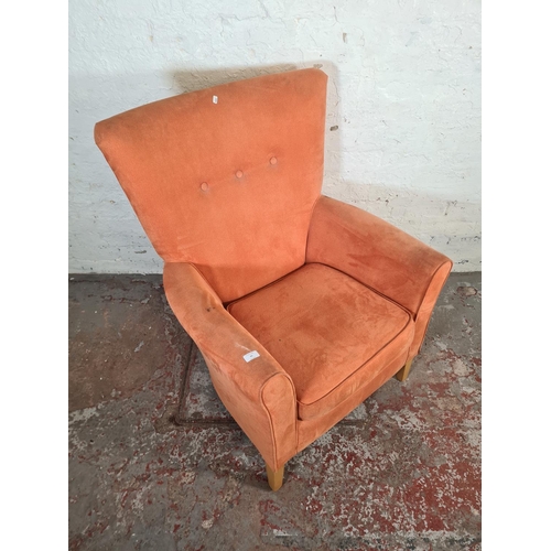 65 - A modern orange fabric upholstered Valencia high back armchair