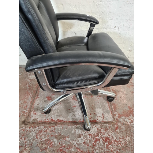 71 - A modern black leatherette and chrome plated swivel office desk chair