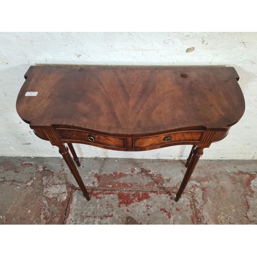 77 - A Bevan Funnell Ltd. Reprodux mahogany serpentine two drawer console table - approx. 73cm high x 80c... 