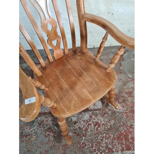 84 - A Victorian style solid beech farmhouse rocking chair