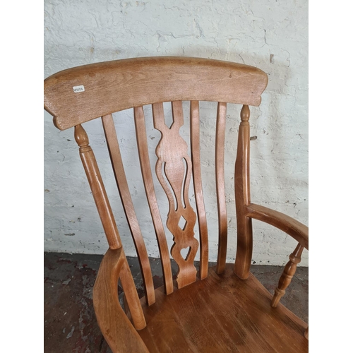 84 - A Victorian style solid beech farmhouse rocking chair