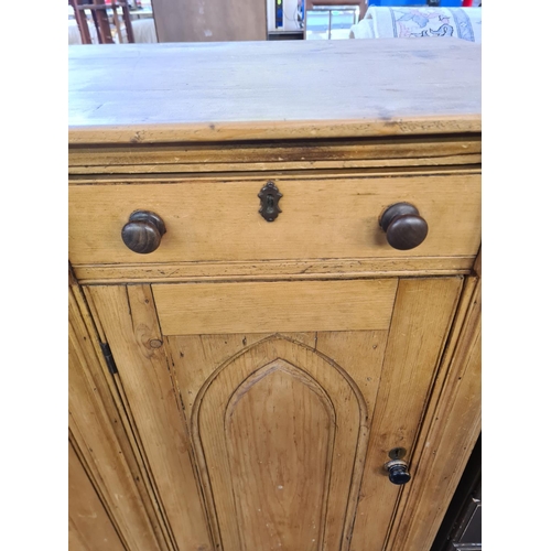 92 - A Victorian Gothic Revival solid pine sideboard with three drawers and three lower cupboard doors - ... 