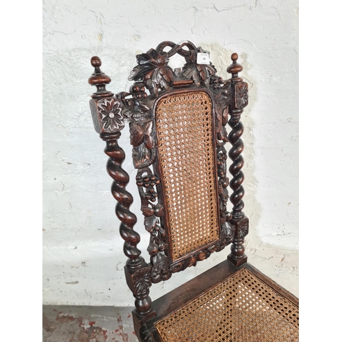 94 - A late Victorian heavily carved oak and rattan high back dining chair with barley twist supports