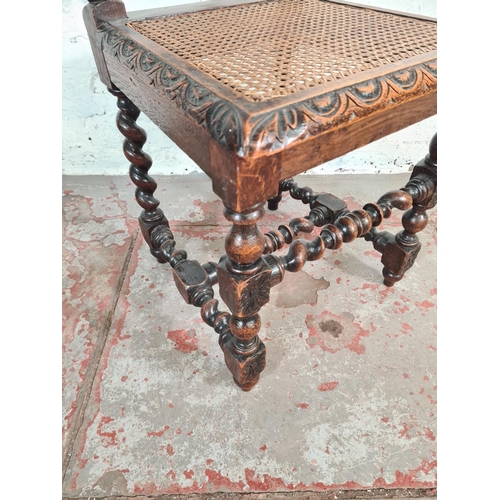 94 - A late Victorian heavily carved oak and rattan high back dining chair with barley twist supports