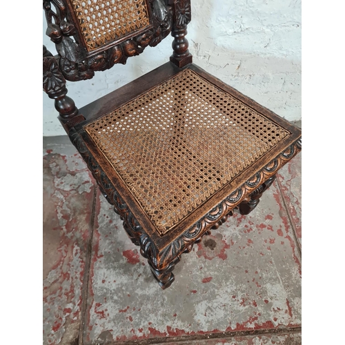 94 - A late Victorian heavily carved oak and rattan high back dining chair with barley twist supports