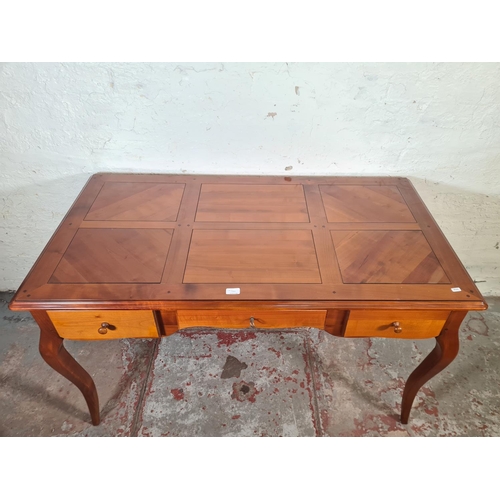 143C - A French Joseph Grange cherry wood writing desk with three drawers - approx. 76cm high x 130cm wide ... 