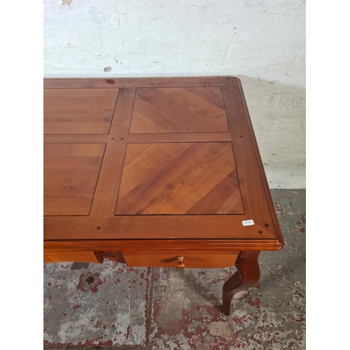 143C - A French Joseph Grange cherry wood writing desk with three drawers - approx. 76cm high x 130cm wide ... 