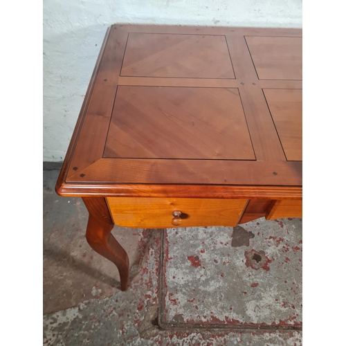 143C - A French Joseph Grange cherry wood writing desk with three drawers - approx. 76cm high x 130cm wide ... 