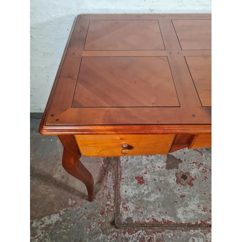 143C - A French Joseph Grange cherry wood writing desk with three drawers - approx. 76cm high x 130cm wide ... 