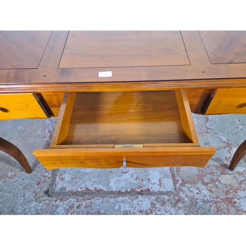 143C - A French Joseph Grange cherry wood writing desk with three drawers - approx. 76cm high x 130cm wide ... 