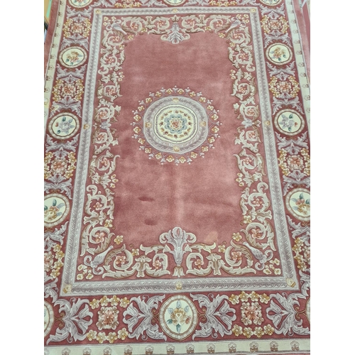 143F - A pink and cream floral patterned tasselled rug - approx. 310cm long x 215cm wide