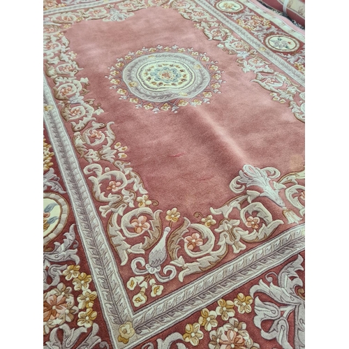 143F - A pink and cream floral patterned tasselled rug - approx. 310cm long x 215cm wide