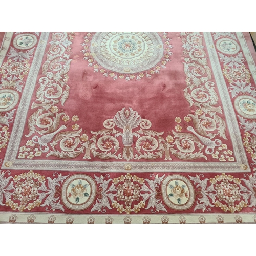 143G - A pink and cream floral patterned tasselled rug - approx. 375cm long x 280cm wide