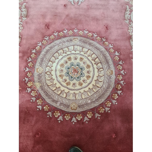 143G - A pink and cream floral patterned tasselled rug - approx. 375cm long x 280cm wide