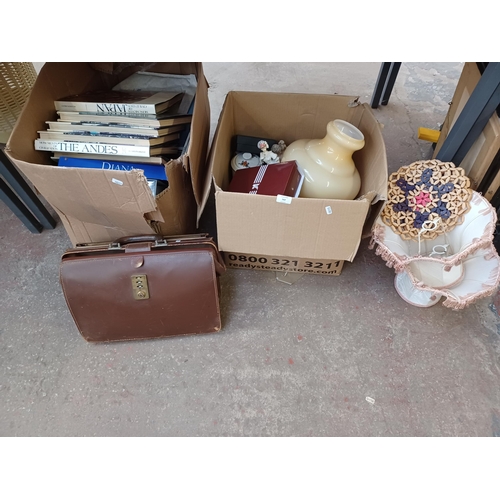 747 - Two boxes containing, books, ceramics, glassware, wooden box, boxed napkin rings, briefcase etc.