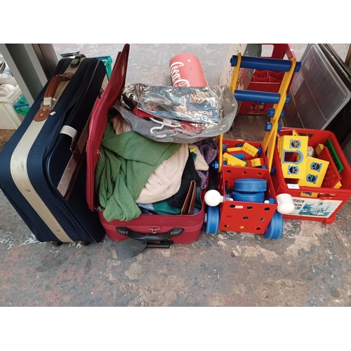 750 - A collection of items to include, building blocks, suitcase containing clothing, empty suitcase etc.