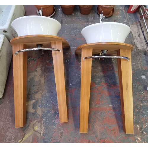 557 - A pair of ceramic sinks on pine effect bases - approx. 117cm high x 60cm wide x 50cm deep