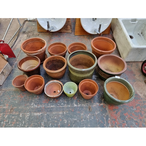 558 - Fifteen terracotta and glazed planters