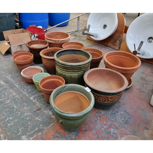 558 - Fifteen terracotta and glazed planters