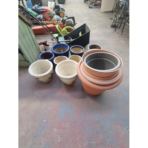 568B - A large collection of various planters to include glazed terracotta, cast stone etc.