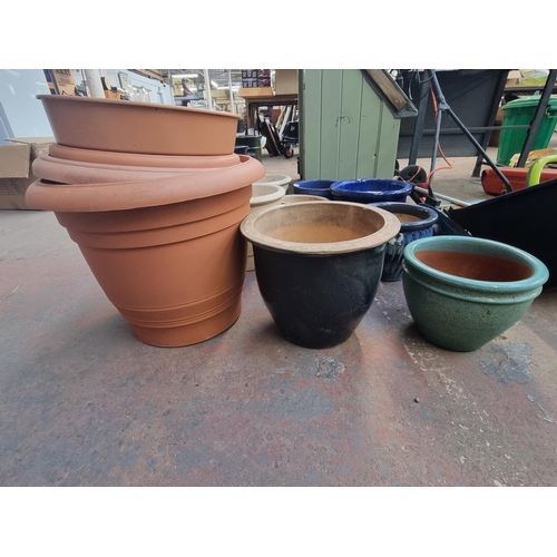 568B - A large collection of various planters to include glazed terracotta, cast stone etc.