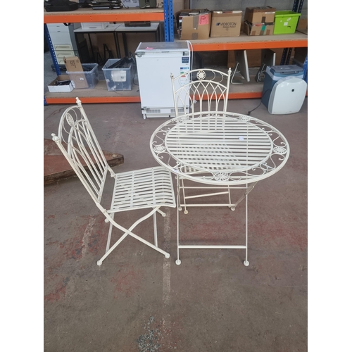 568C - A French style wrought iron three-piece patio set comprising table and two chairs