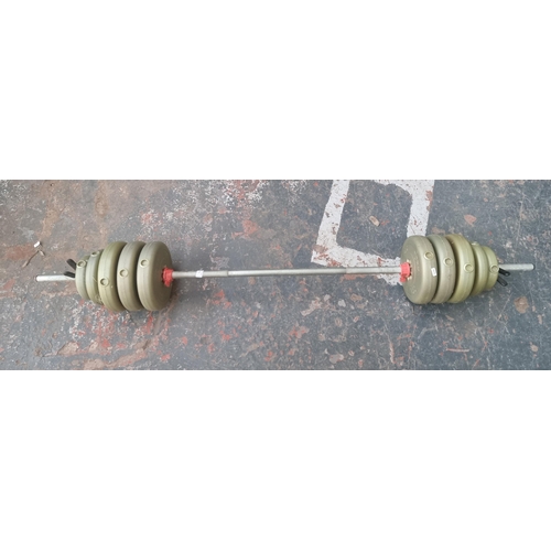 571 - A barbell with five pairs of various sized weights