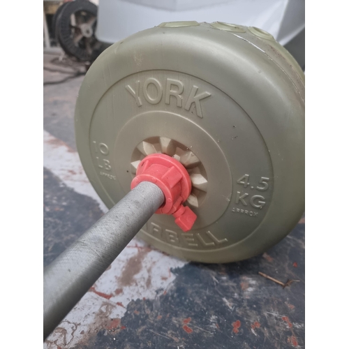 571 - A barbell with five pairs of various sized weights