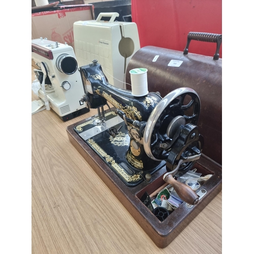 713 - A cased Singer hand crack sewing machine with accessories - serial number Y2120995