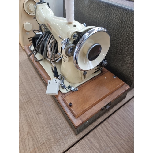 716 - A cased Sherwood electric sewing machine with foot pedal