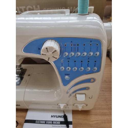 717 - A boxed Hyundai sixty stitch electric sewing machine with foot pedal and instruction manual