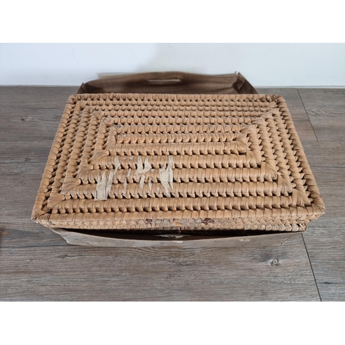 513 - An early 20th century wicker basket with canvas casing - approx. 15cm high x 44cm wide x 27cm deep