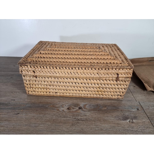 513 - An early 20th century wicker basket with canvas casing - approx. 15cm high x 44cm wide x 27cm deep