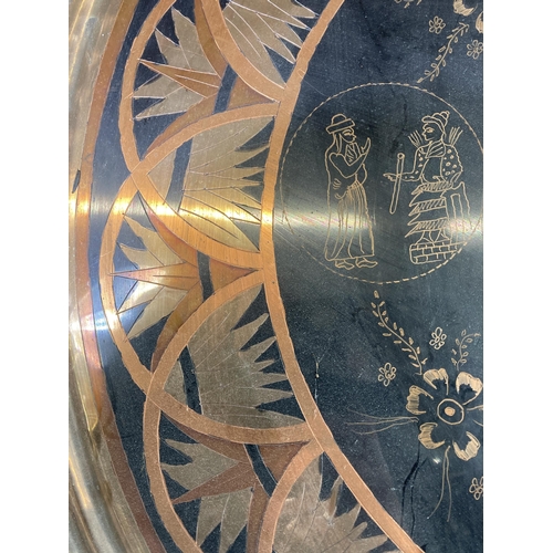 304 - A mid 20th century Oriental engraved copper charger - approx. 60cm diameter