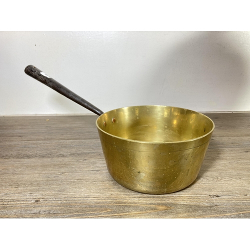 316 - Five pieces of antique and vintage metalware to include Victorian brass saucepan, brass fish design ... 