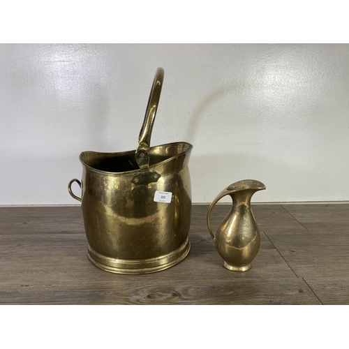 322 - A collection of brass and copperware to include Victorian kettle, two coal scuttles, horse brasses e... 