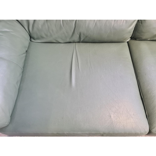 73A - A modern green leather three seater sofa