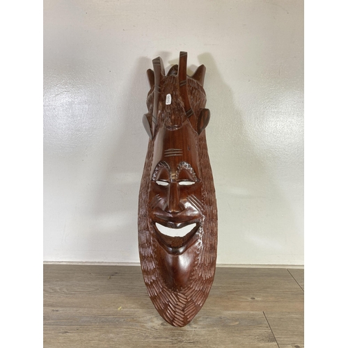 487 - Three pieces of treenware, one African carved hardwood tribal wall mask - approx. 63cm high, one car... 