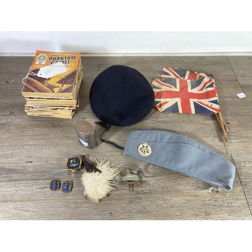 498 - A collection of militaria to include Royal Lincolnshire Regiment cap badge, thirteen Air Ace picture... 