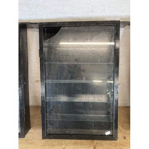 502 - Three vintage black painted and glass wall mountable display cabinets - approx. 63cm high x 52cm wid... 