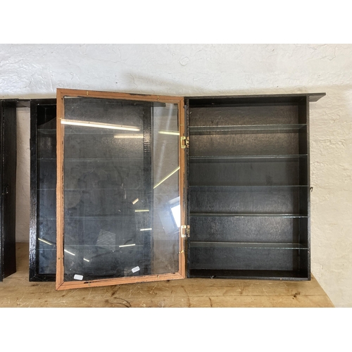 502 - Three vintage black painted and glass wall mountable display cabinets - approx. 63cm high x 52cm wid... 