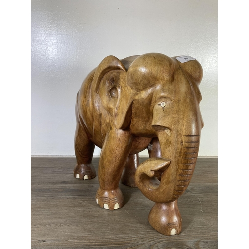 507 - A carved teak elephant statue - approx. 37cm high x 21cm wide x 40cm deep