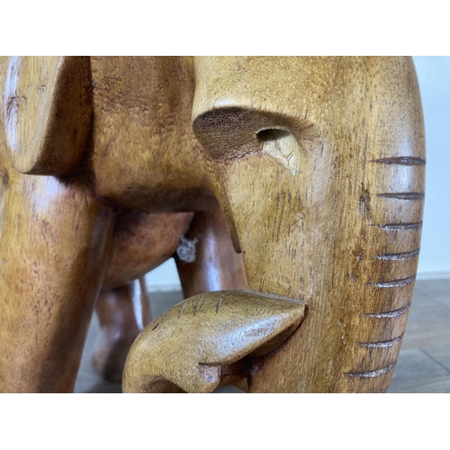 507 - A carved teak elephant statue - approx. 37cm high x 21cm wide x 40cm deep