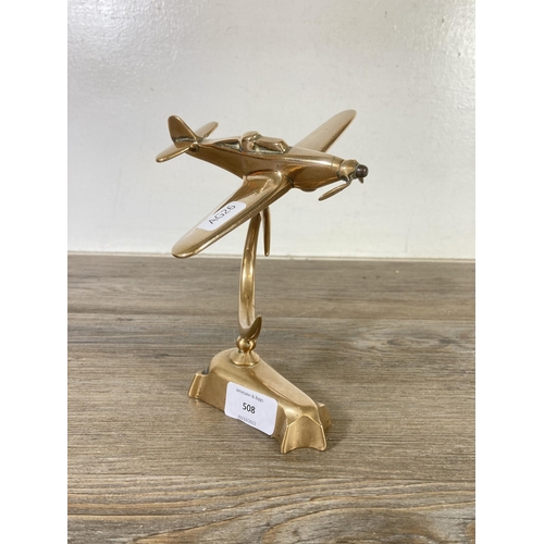 508 - A mid 20th century brass model of a spitfire